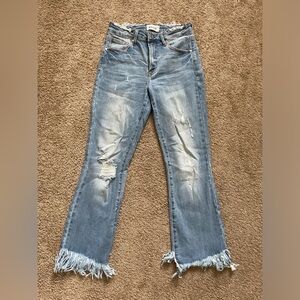 Women’s medium wash distressed fringe bottom denim jeans